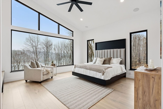 bedroom with baseboards, hardwood / wood-style flooring, and recessed lighting