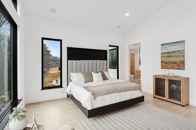 bedroom featuring high vaulted ceiling, light wood finished floors, recessed lighting, and baseboards