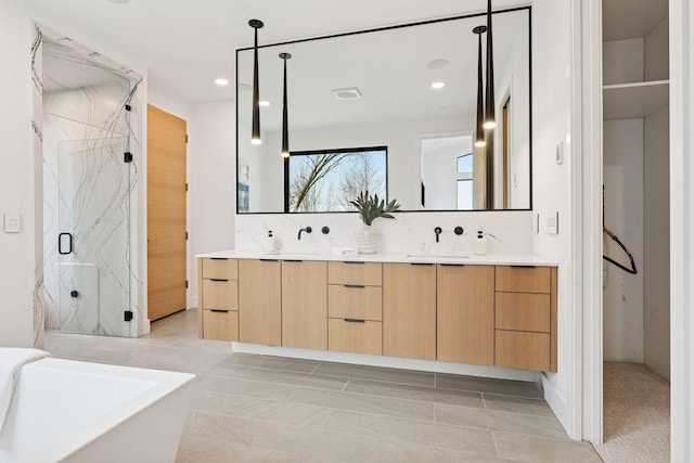 bathroom with a marble finish shower, double vanity, tasteful backsplash, recessed lighting, and a soaking tub