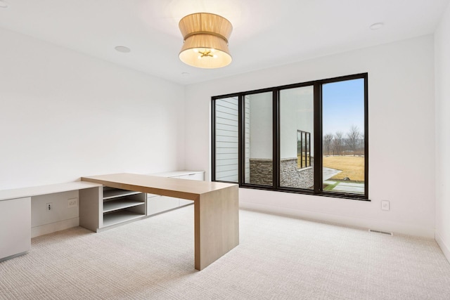 home office with carpet, visible vents, and baseboards