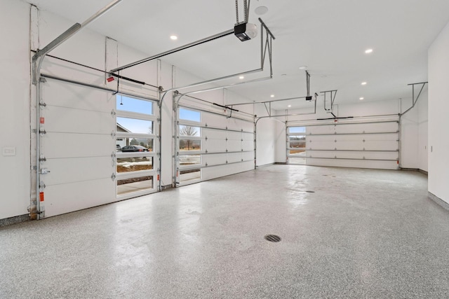 garage with recessed lighting, baseboards, and a garage door opener