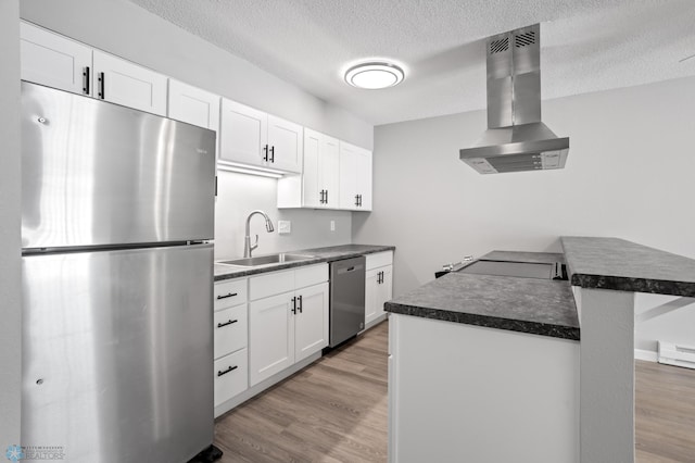 kitchen featuring sink, light hardwood / wood-style flooring, appliances with stainless steel finishes, white cabinets, and island exhaust hood