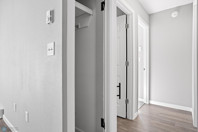 corridor with light hardwood / wood-style floors