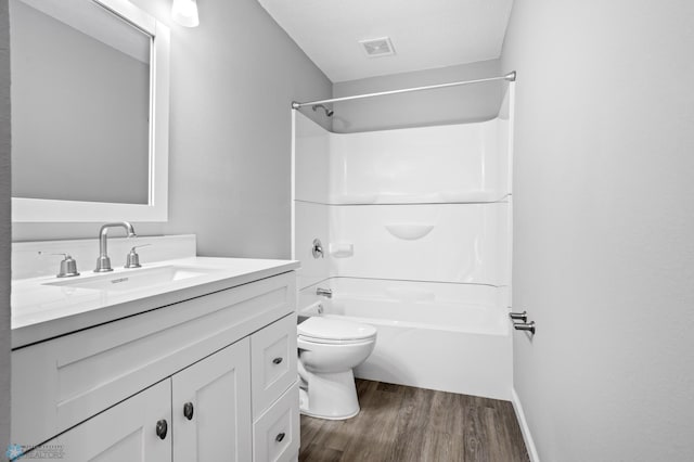 full bathroom with toilet, vanity, bathtub / shower combination, and hardwood / wood-style floors