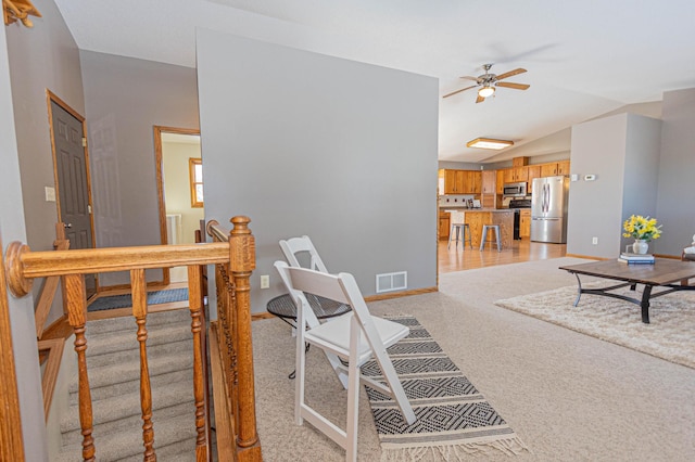 living room with lofted ceiling and ceiling fan