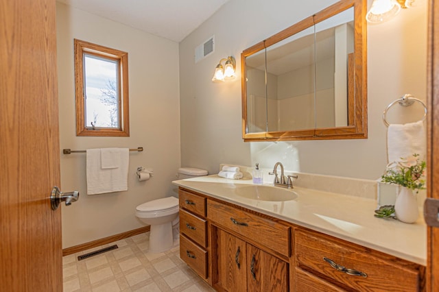 bathroom with toilet and vanity