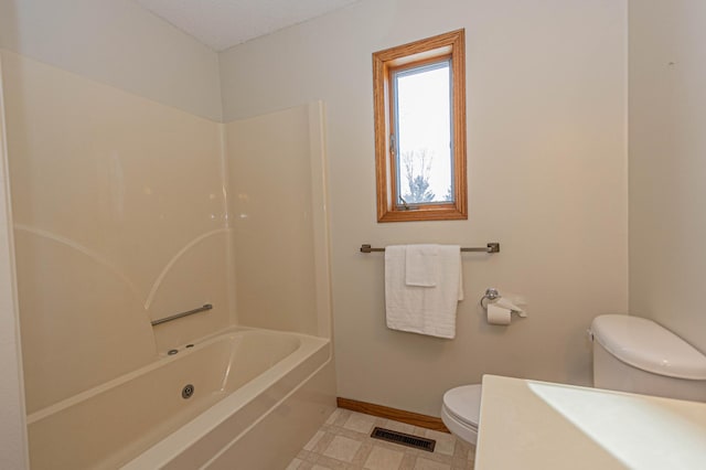 bathroom with washtub / shower combination and toilet