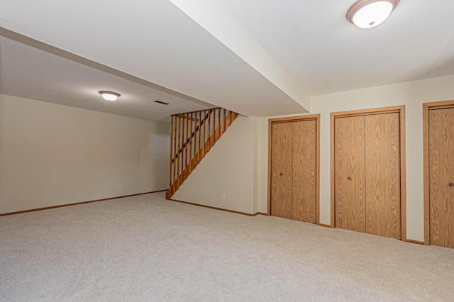 basement with carpet flooring and a textured ceiling