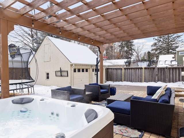 exterior space with a pergola, a hot tub, a trampoline, and fence