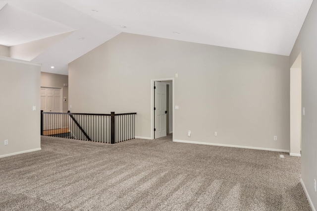 unfurnished room with high vaulted ceiling, baseboards, and carpet