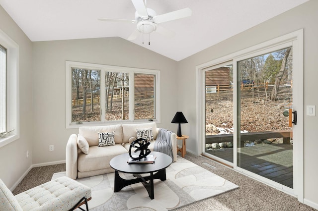 living room featuring vaulted ceiling, a wealth of natural light, and light carpet