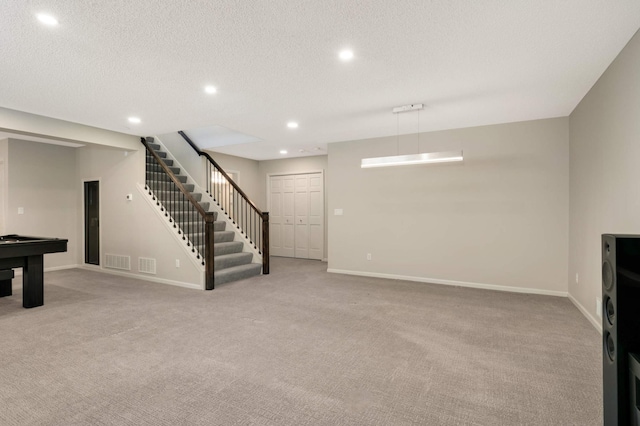 interior space with stairway, recessed lighting, baseboards, and a textured ceiling