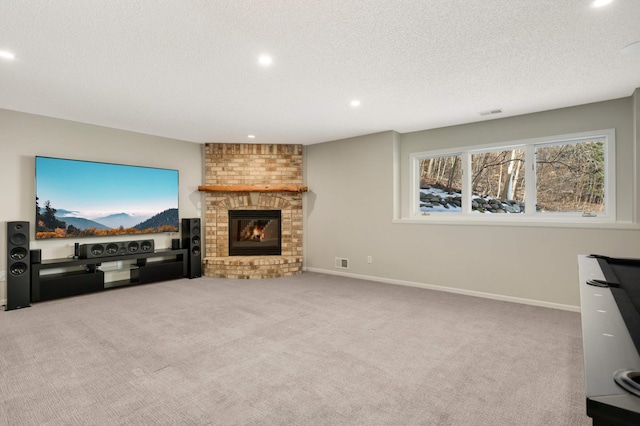 living room featuring carpet, baseboards, visible vents, a textured ceiling, and a brick fireplace