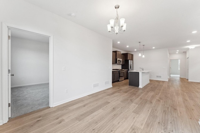 unfurnished living room featuring visible vents, recessed lighting, baseboards, and light wood-style floors