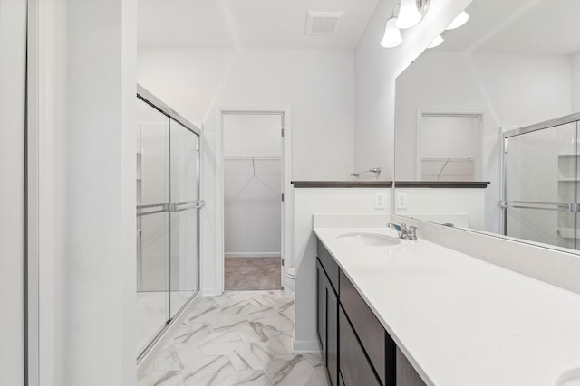 bathroom featuring vanity, a shower stall, visible vents, and marble finish floor