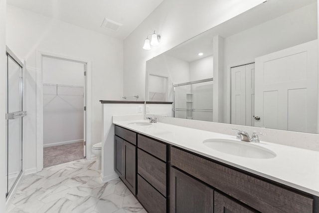 bathroom with visible vents, double vanity, a stall shower, marble finish floor, and a sink