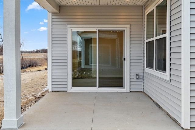 entrance to property featuring a patio area