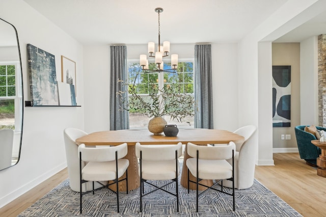 dining space featuring hardwood / wood-style flooring and a chandelier