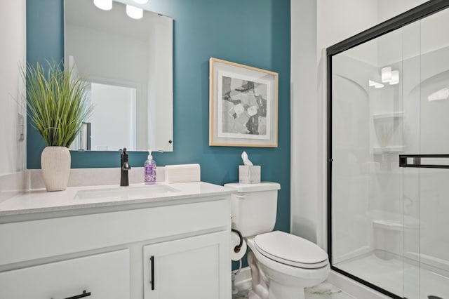 bathroom featuring an enclosed shower, vanity, and toilet