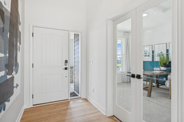 entryway featuring french doors and light wood-type flooring