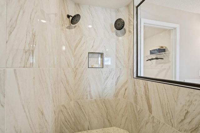 bathroom with a tile shower