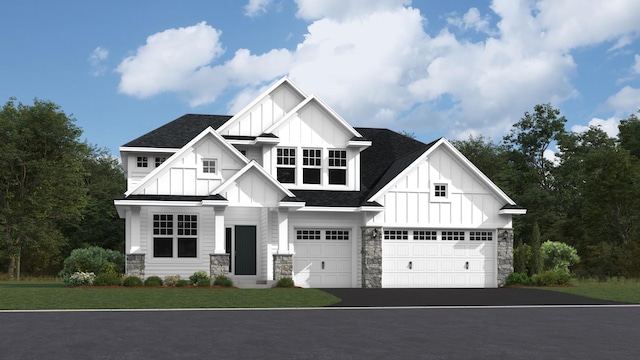 view of front of house featuring a garage and a front lawn