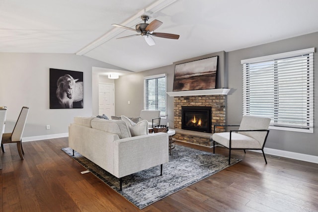 living room featuring a brick fireplace, dark hardwood / wood-style floors, and plenty of natural light