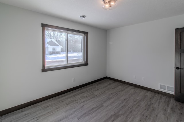 unfurnished room with wood-type flooring