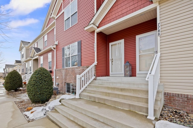 doorway to property with brick siding