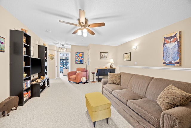 carpeted living area featuring baseboards, a textured ceiling, and a ceiling fan