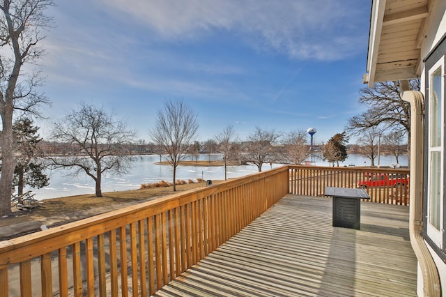 snow covered deck featuring a water view