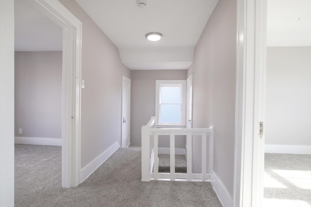 hallway featuring light carpet