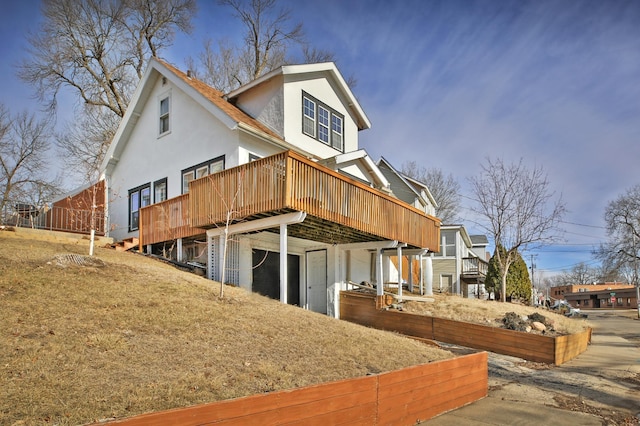 back of house with a wooden deck