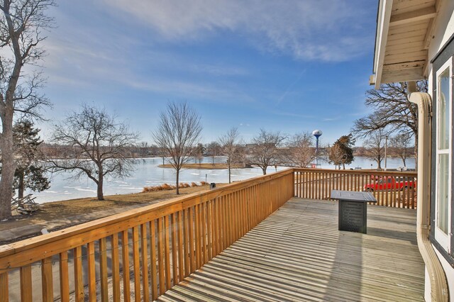 wooden deck featuring a water view