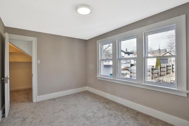 spare room with carpet and baseboards