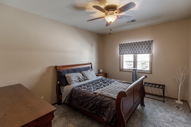 bedroom featuring ceiling fan, carpet, and a textured ceiling