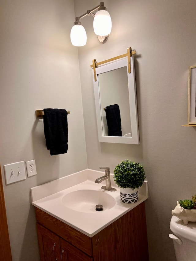 bathroom featuring toilet and vanity