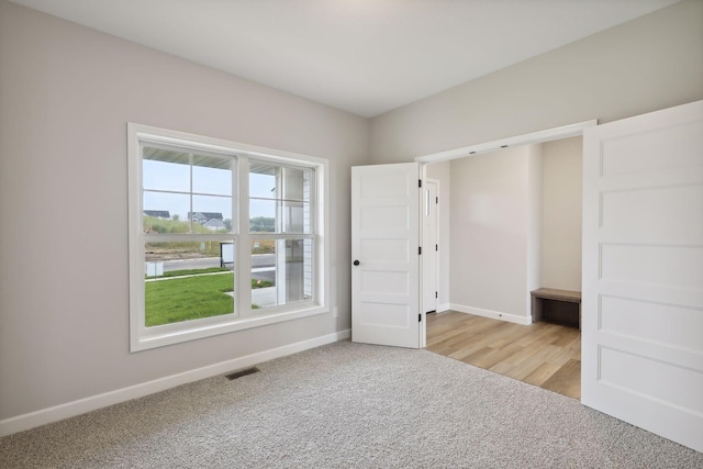 unfurnished bedroom featuring light carpet