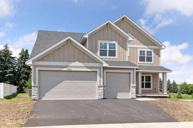 17953 Hidden Creek Trl, Lakeville, MN 55044 - craftsman-style house featuring a shingled roof, asphalt driveway, and board and batten siding
