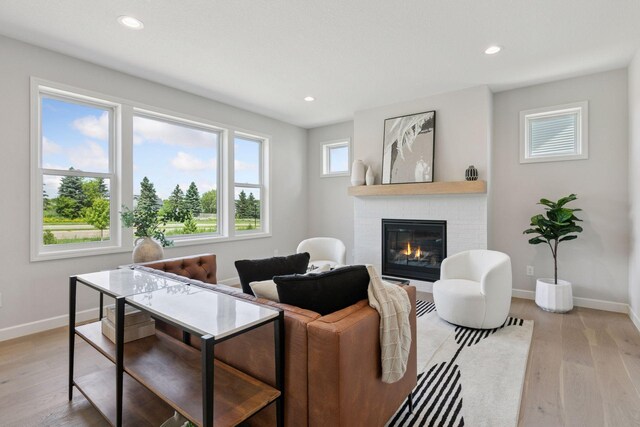 17953 Hidden Creek Trl, Lakeville, MN 55044 - living room with a fireplace, light wood-type flooring, and recessed lighting