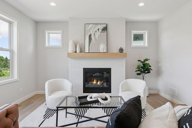 17953 Hidden Creek Trl, Lakeville, MN 55044 - living room with wood finished floors, a brick fireplace, and recessed lighting