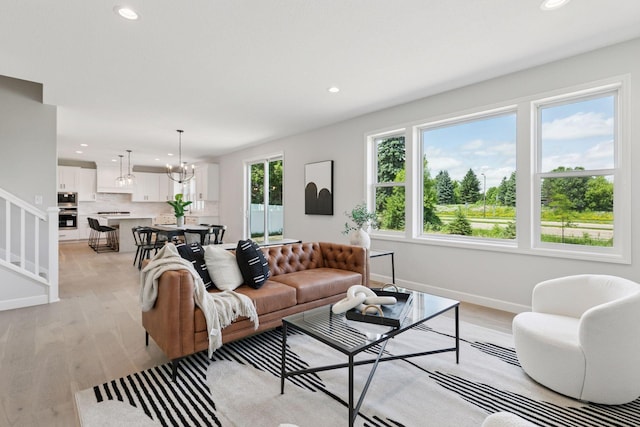 17953 Hidden Creek Trl, Lakeville, MN 55044 - living area with recessed lighting, light wood-style floors, a chandelier, and stairs