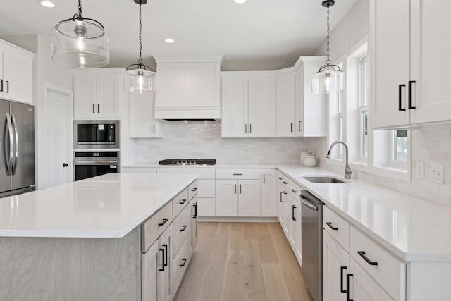17953 Hidden Creek Trl, Lakeville, MN 55044 - kitchen featuring stainless steel appliances, a center island, recessed lighting, light wood finished floors, and light countertops