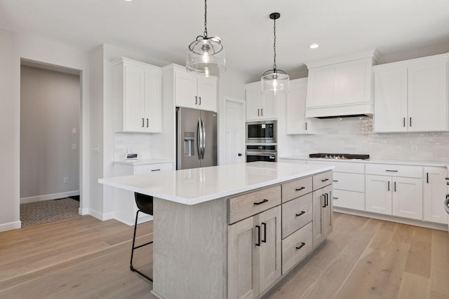17953 Hidden Creek Trl, Lakeville, MN 55044 - kitchen with appliances with stainless steel finishes, a center island, decorative backsplash, light countertops, and recessed lighting