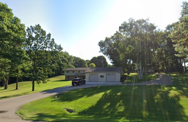 view of front of property featuring a garage and a front yard