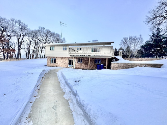 snow covered house with a deck