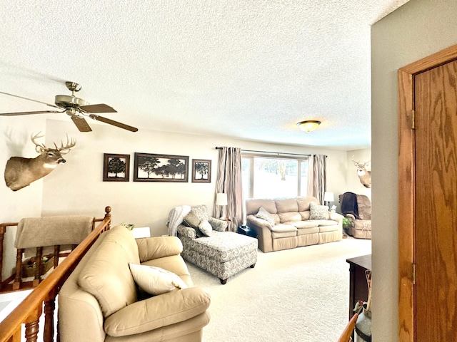 living room with a textured ceiling, carpet flooring, and ceiling fan