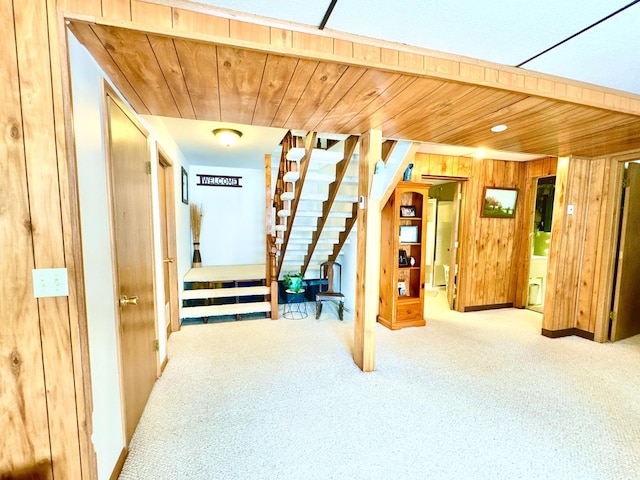 bonus room with carpet, wood walls, and wooden ceiling