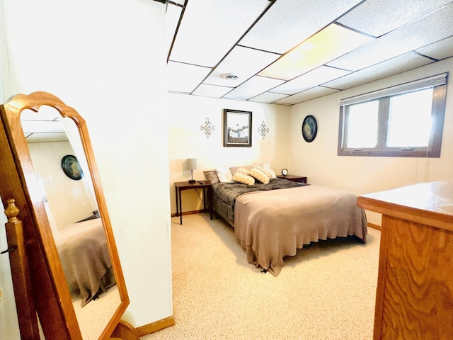 carpeted bedroom featuring a paneled ceiling