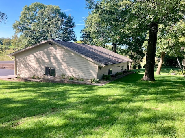 view of side of home with a lawn